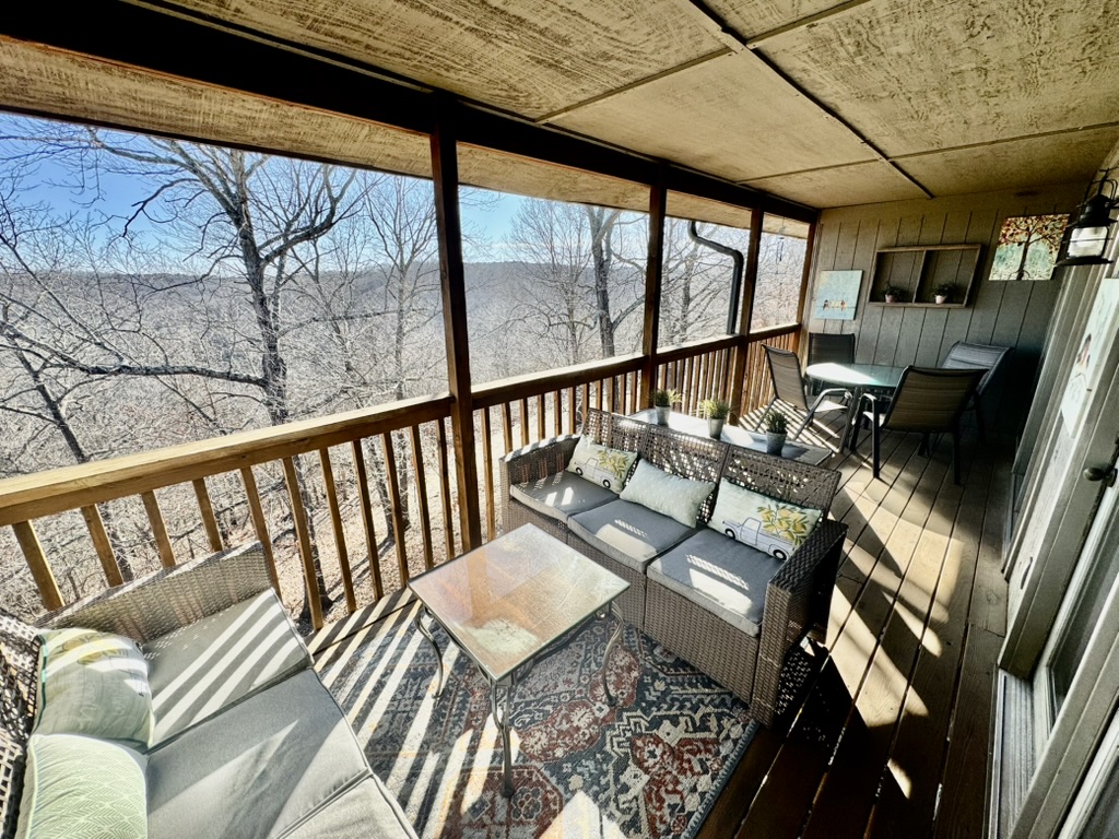 Screened porch overlooking the Ozarks — real Summers Vacations property